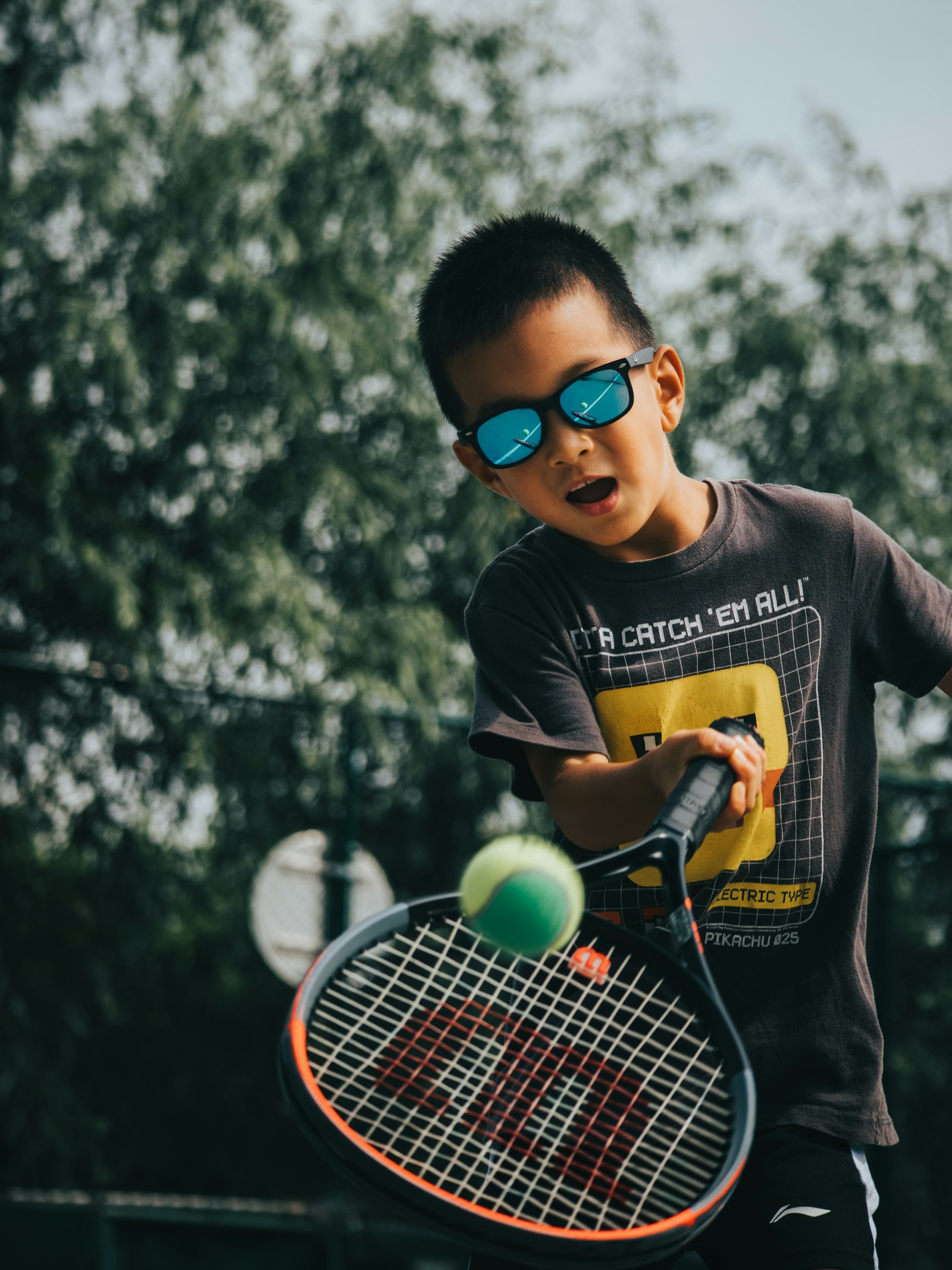 Young boy holding a tennis racquet on a court, illustrating the Teddy Tennis toddler programme at Baseline Tennis Academy in DHA, Karachi